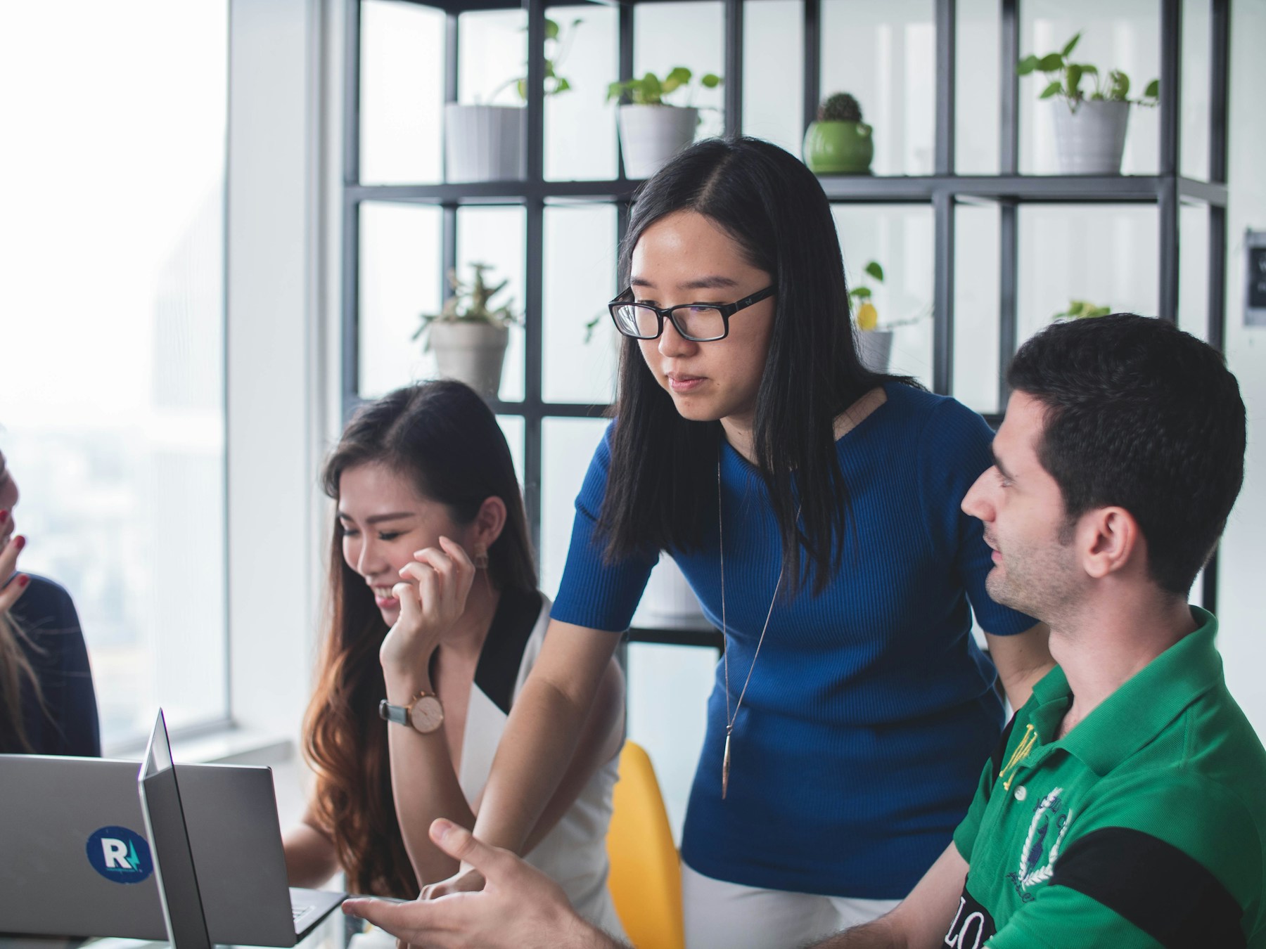 Technology professionals collaborating around a shared workspace