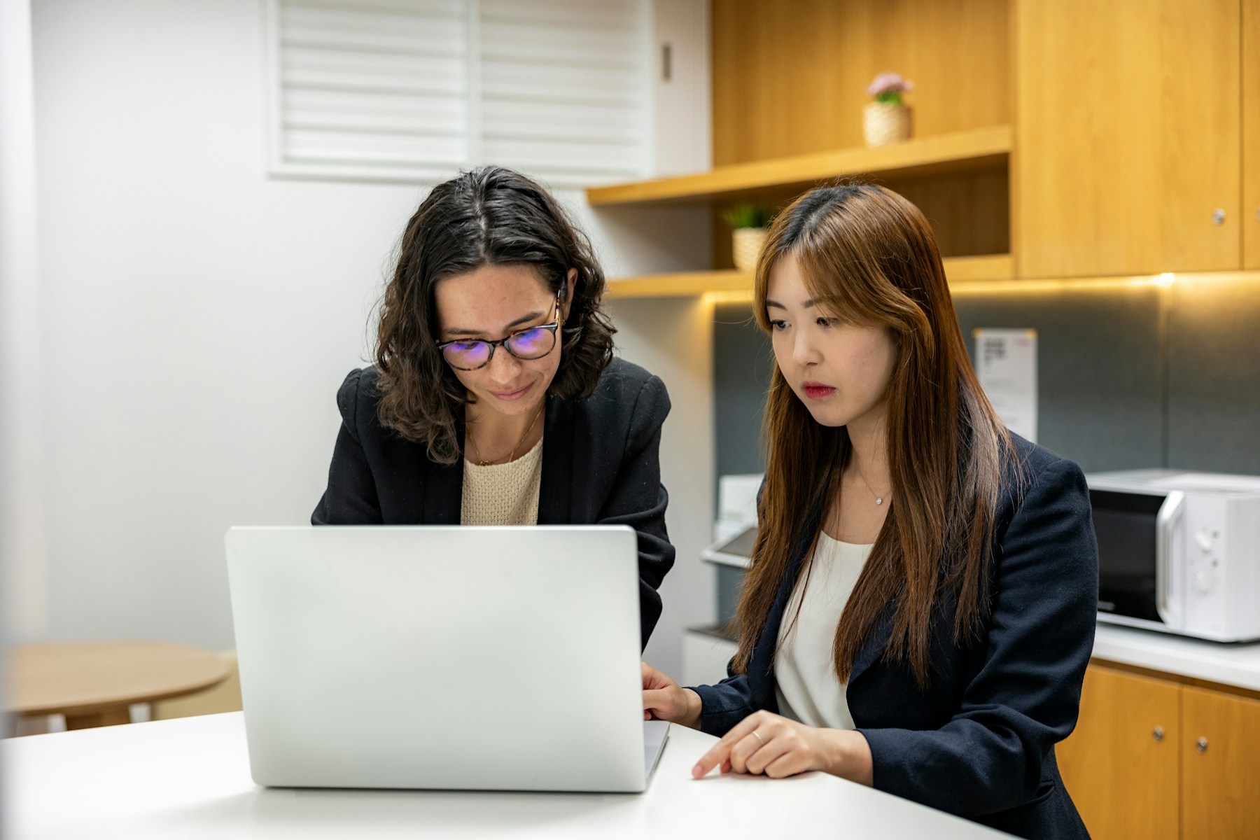 Two colleagues working together in a bright professional environment